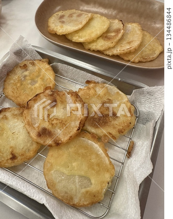 Golden-brown gamja jeon, a classic Korean potato pancake, crispy on the outside and tender inside. Simple yet flavorful, it's a comforting snack or side dish to enjoy anytime. 134486844