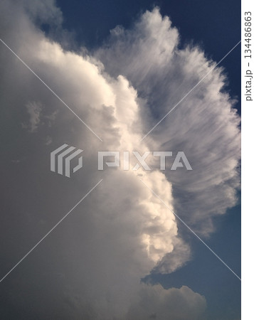 Blue sky filled with fluffy white clouds scattered across, creating a serene and peaceful scene with soft shapes and natural light forming a calm and refreshing atmosphere 134486863