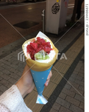 Thin crepes with soft, golden surface and slightly crisp edges, folded neatly to showcase their delicate texture, warm color, and light airy appearance in close-up detail 134486871