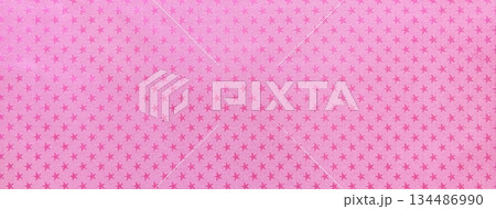 Pink paper background with lilac metal foil pattern of magenta stars for Christmas or New Year backdrop Pink paper background with lilac metal foil pattern of magenta stars for Christmas or New Year backdrop 134486990
