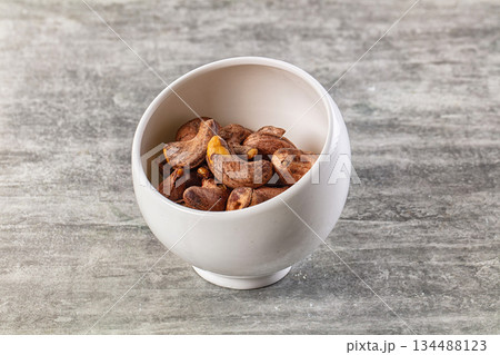 Unpeeled cashew nuts in the bowl 134488123