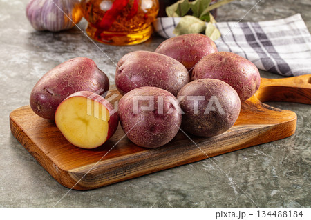 Raw red organic potato over board 134488184