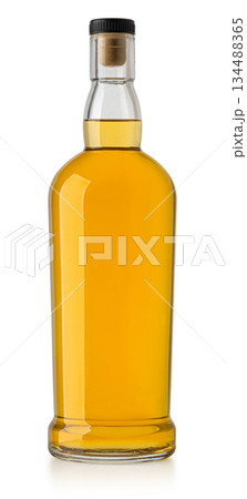 Whiskey bottle with cork stopper containing golden liquor 134488365