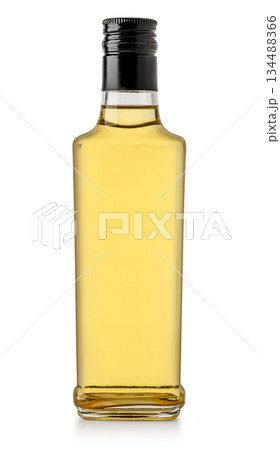 Glass bottle holding apple cider vinegar condiment Glass bottle holding apple cider vinegar condiment 134488366
