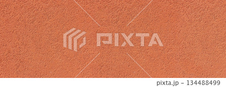 Orange stucco wall rough textured surface background 134488499