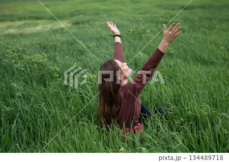 Woman field nature arms up happy freedom green grass 134489718
