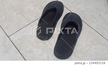 4k detailed black sandals on ceramic floor 4k detailed black sandals on ceramic floor 134491516