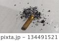 4k closeup cigarette butt with scattered ashes 134491521