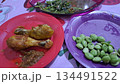 Fried chicken and fresh vegetable side dishes on colorful plates captured in 4k 134491522