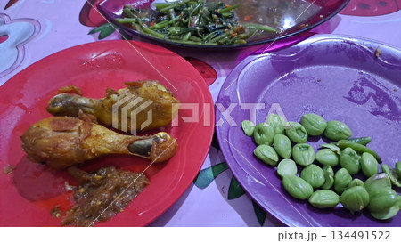 Fried chicken and fresh vegetable side dishes on colorful plates captured in 4k Fried chicken and fresh vegetable side dishes on colorful plates captured in 4k 134491522