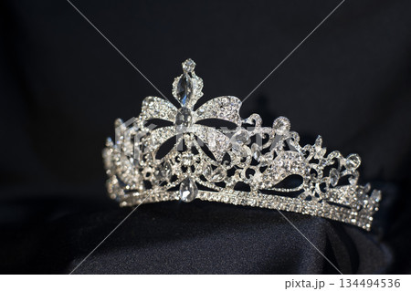 Luxury golden royal crown, diadem with bow detail. 134494536