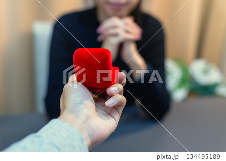 Close up of red velvet engagement ring box with blurred background Close up of red velvet engagement ring box with blurred background 134495189