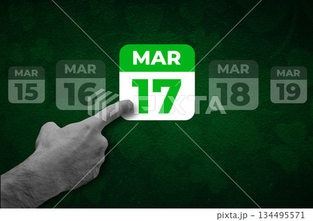 St. Patrick Day calendar, March 17. Halftone collage: a hand pointing to a calendar with the date March 17. 134495571