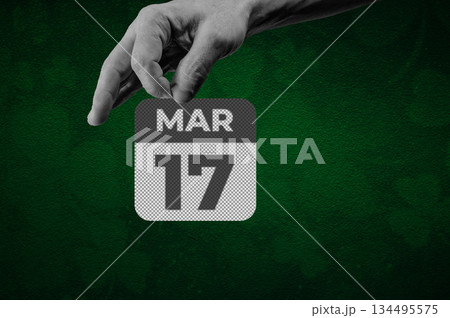 St Patrick day March 17th Calendar Page. Halftone collage of a hand holding a calendar page with the words March 17 134495575
