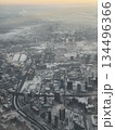 Panoramic aerial view of winter city with snowy rooftops and roads at sunrise. 134496366