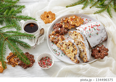 Traditional German Christmas Stollen with marzipan and cookies on white wooden table Traditional German Christmas Stollen with marzipan and cookies on white wooden table 134496375