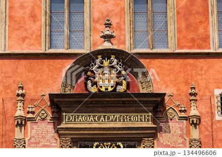 Renaissance tripartite window on Prague Old Town Hall featuring the Latin inscription Praga caput regni and the Old Town coat of arms on a historic stone facade, Prague, Czech republic 134496606