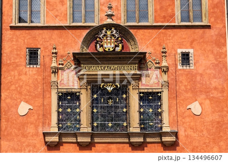Renaissance tripartite window on Prague Old Town Hall featuring the Latin inscription Praga caput regni and the Old Town coat of arms on a historic stone facade, Prague, Czech republic 134496607
