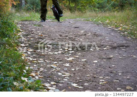 man rides down the trail on a monocycle. close up unicycle. 134497227