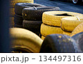 stack of car tires black and yellow, for racing track fencing 134497316