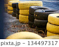 stack of car tires black and yellow, for racing track fencing 134497317