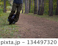 man rides down the trail on a monocycle. close up unicycle. 134497320