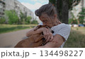 Animal theme is a lonely old woman best friend. Caucasian 90 years old senior female is happy to spend time with her pet small dachshund dog, holding her in her arms, hugging hugs and kisses outdoor 134498227