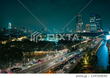 illuminated big city skyline at night, cars on road at rush hour, Lumpini park with festive street lights, high-rise skyscrapers and downtown glow at evening, Dusit Central, Bangkok Thailand 134500640