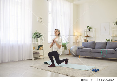 Yogi old sporty senior, fit woman knee practicing, stretching, yoga at home, exercise, relax pose Yogi old sporty senior, fit woman knee practicing, stretching, yoga at home, exercise, relax pose 134500832