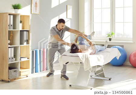 Professional physiotherapist or chiropractor working with a patient at the clinic 134500861