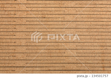 Detailed Texture of Slotted Brown Wood Fiberboard Surface Background Detailed Texture of Slotted Brown Wood Fiberboard Surface Background 134501757