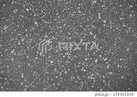 Grey speckled stone non-stick coating texture background 134501830
