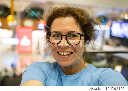 Video call portrait of excited cheerful smiling woman in spectacles taking selfie photo. Selfie and blogger concept Video call portrait of excited cheerful smiling woman in spectacles taking selfie photo. Selfie and blogger concept 134502102