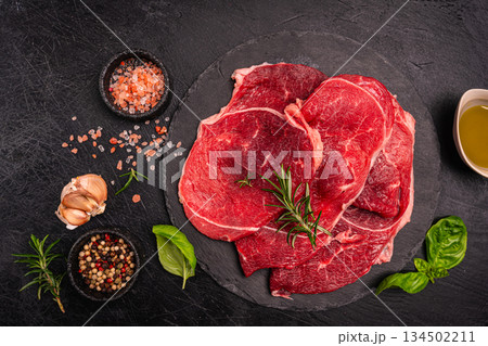 Raw organic steak with ingredients for cooking Raw organic steak with ingredients for cooking 134502211