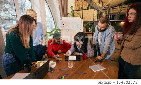 Diverse coworkers discussing ideas during office meeting Diverse coworkers discussing ideas during office meeting 134502375
