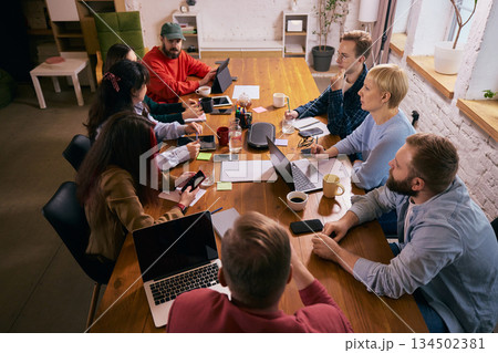 Creative team meeting viewed from above in modern office. Creative team meeting viewed from above in modern office. 134502381
