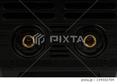 Close-up of welding machine front panel sockets and vents Close-up of welding machine front panel sockets and vents 134502704