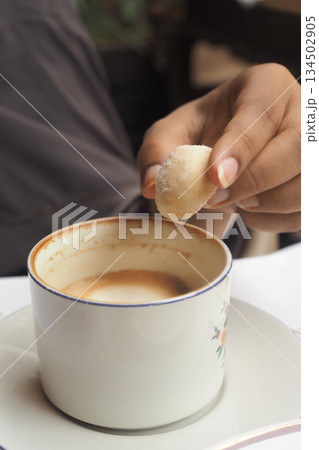 Enjoying coffee and sweet treat in a cafe setting Enjoying coffee and sweet treat in a cafe setting 134502905