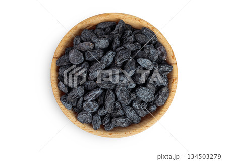black raisins in wooden bowl isolated on white background. Top view. Flat lay 134503279