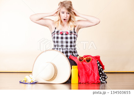 Young woman packing suitcase 134503655