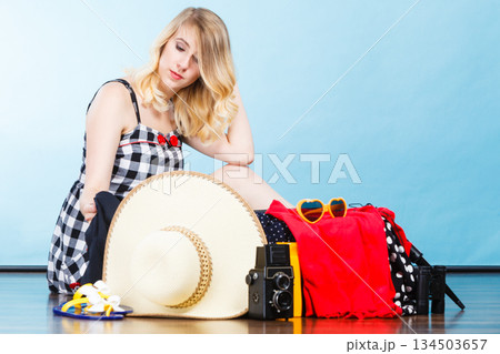 Young woman packing suitcase 134503657