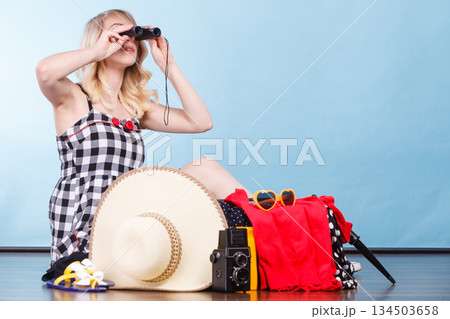 Young woman packing suitcase 134503658