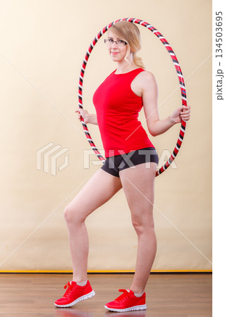 Fit woman with hula hoop doing exercise Fit woman with hula hoop doing exercise 134503695