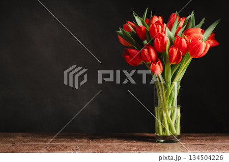Spring flowers in a vase. A bouquet of fresh red tulips, birthday or easter background Spring flowers in a vase. A bouquet of fresh red tulips, birthday or easter background 134504226