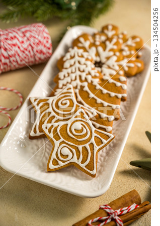 Holiday background. Christmas gingerbread cookies, festive food, home baking. Flat lay Holiday background. Christmas gingerbread cookies, festive food, home baking. Flat lay 134504256