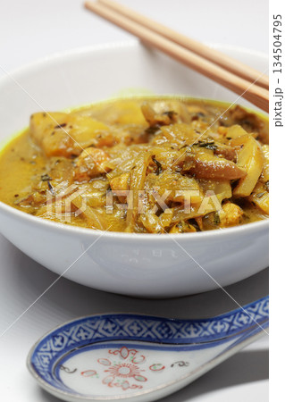 Asian soup with chopsticks and a porcelain spoon Asian soup with chopsticks and a porcelain spoon 134504795