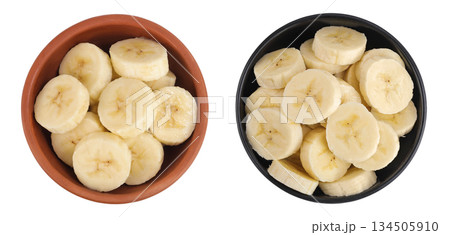 peeled banana pieces in ceramic bowl isolated on white background. Top view. Flat lay. 134505910