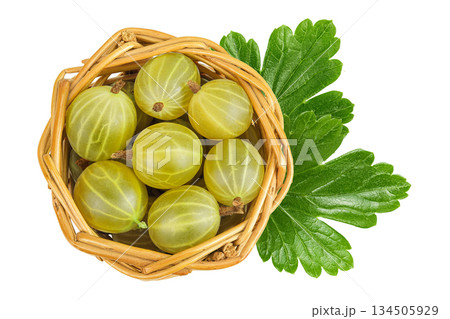 Green gooseberry in a wicker basket isolated on white background. Top view. Flat lay. 134505929