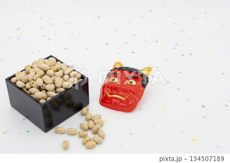 カラフル和紙背景に置かれた枡入りの煎り大豆と赤鬼のお面 節分イメージ カラフル和紙背景に置かれた枡入りの煎り大豆と赤鬼のお面 節分イメージ 134507189