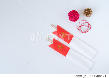 紅白の箸袋に入った祝い箸とお正月飾り 紅白の箸袋に入った祝い箸とお正月飾り 134508471